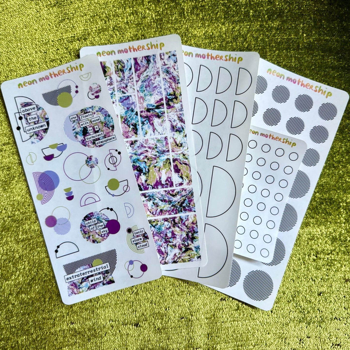 Set of planner stickers on a textured green surface