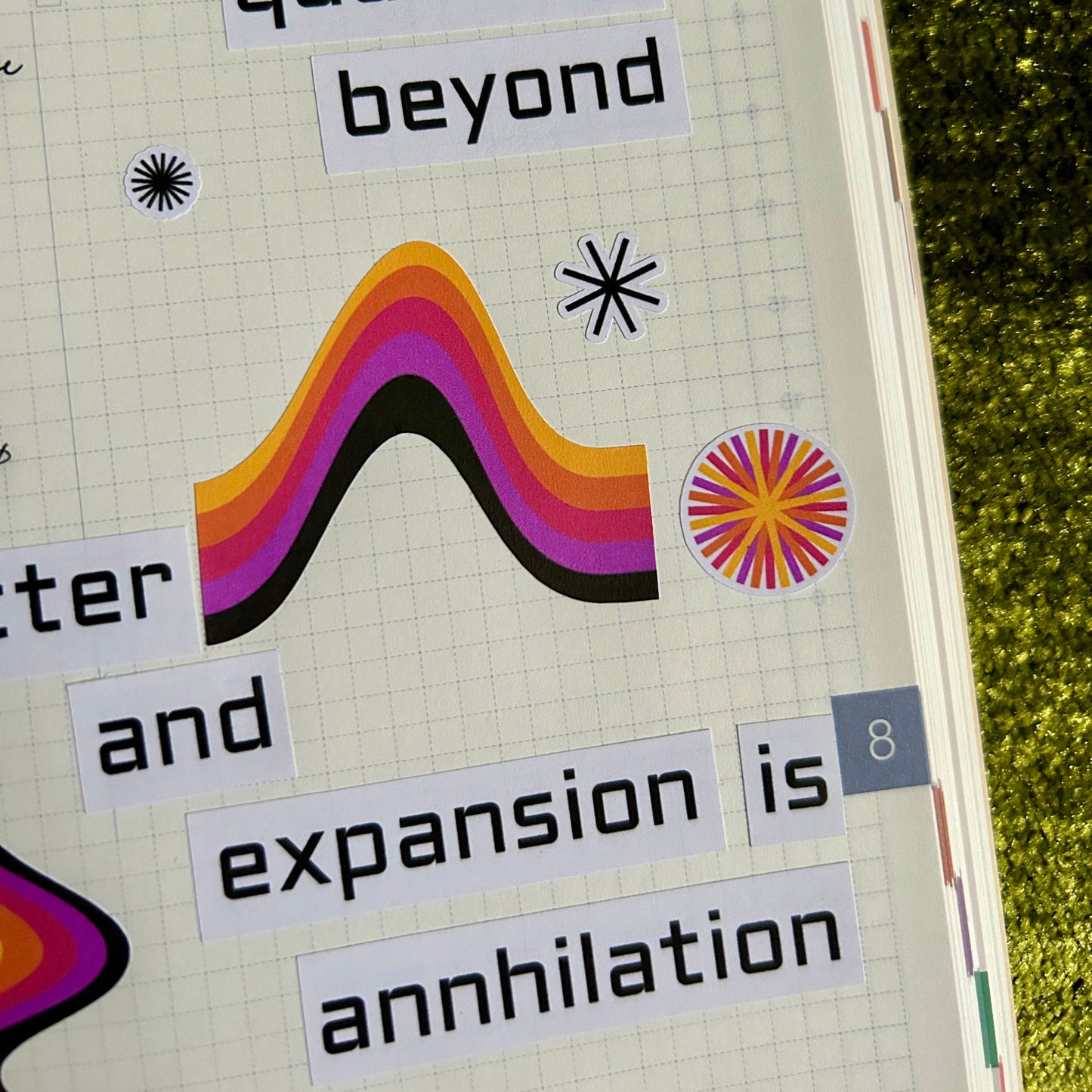 Notebook page with text and abstract designs on a textured green surface