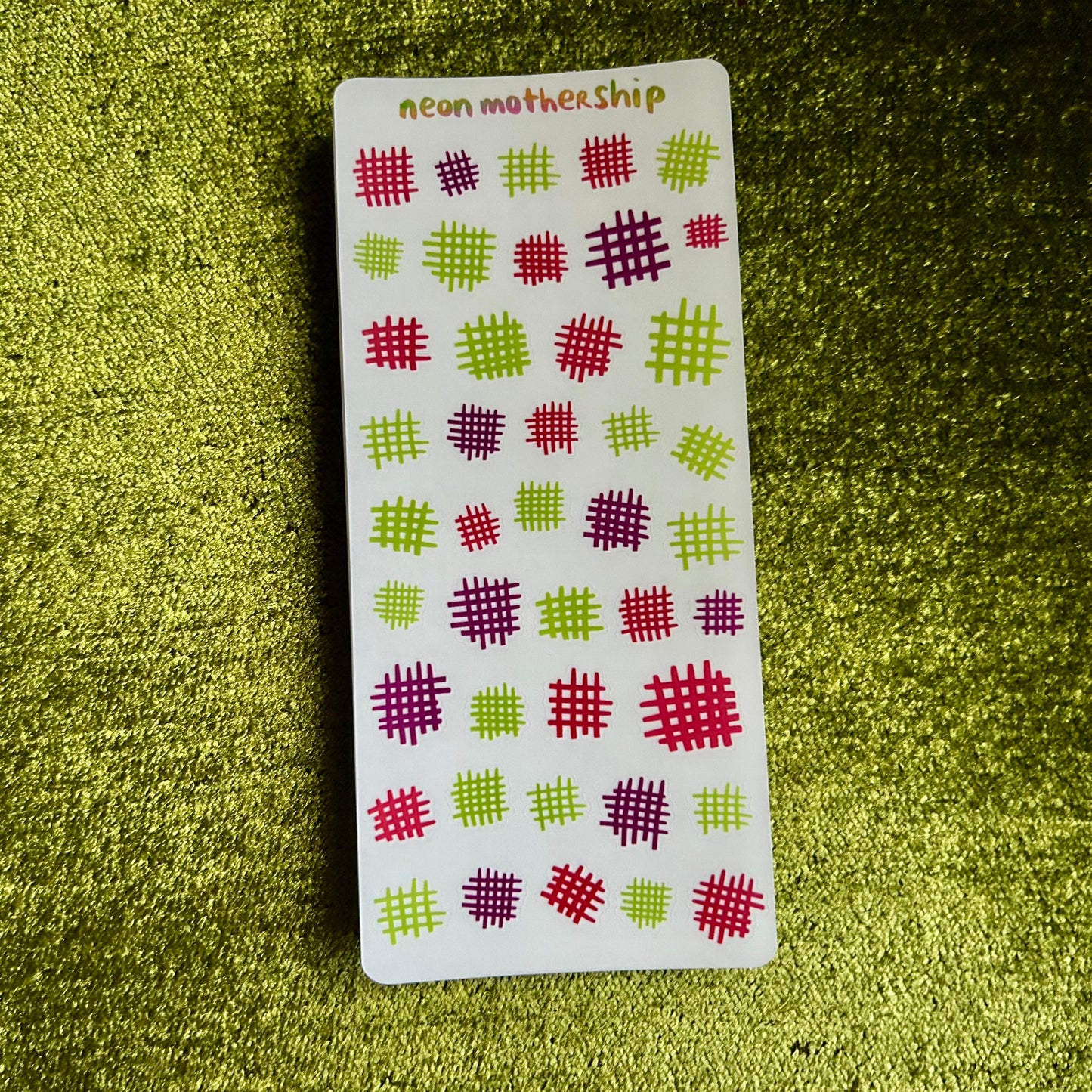 Card with geometric pattern on a green textured surface