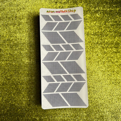 sticker sheet with geometric pattern on a green textured surface