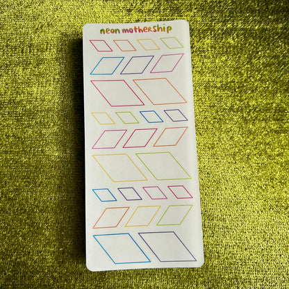 Sheet of geometric stickers with 'neon mothership' branding on a green textured background