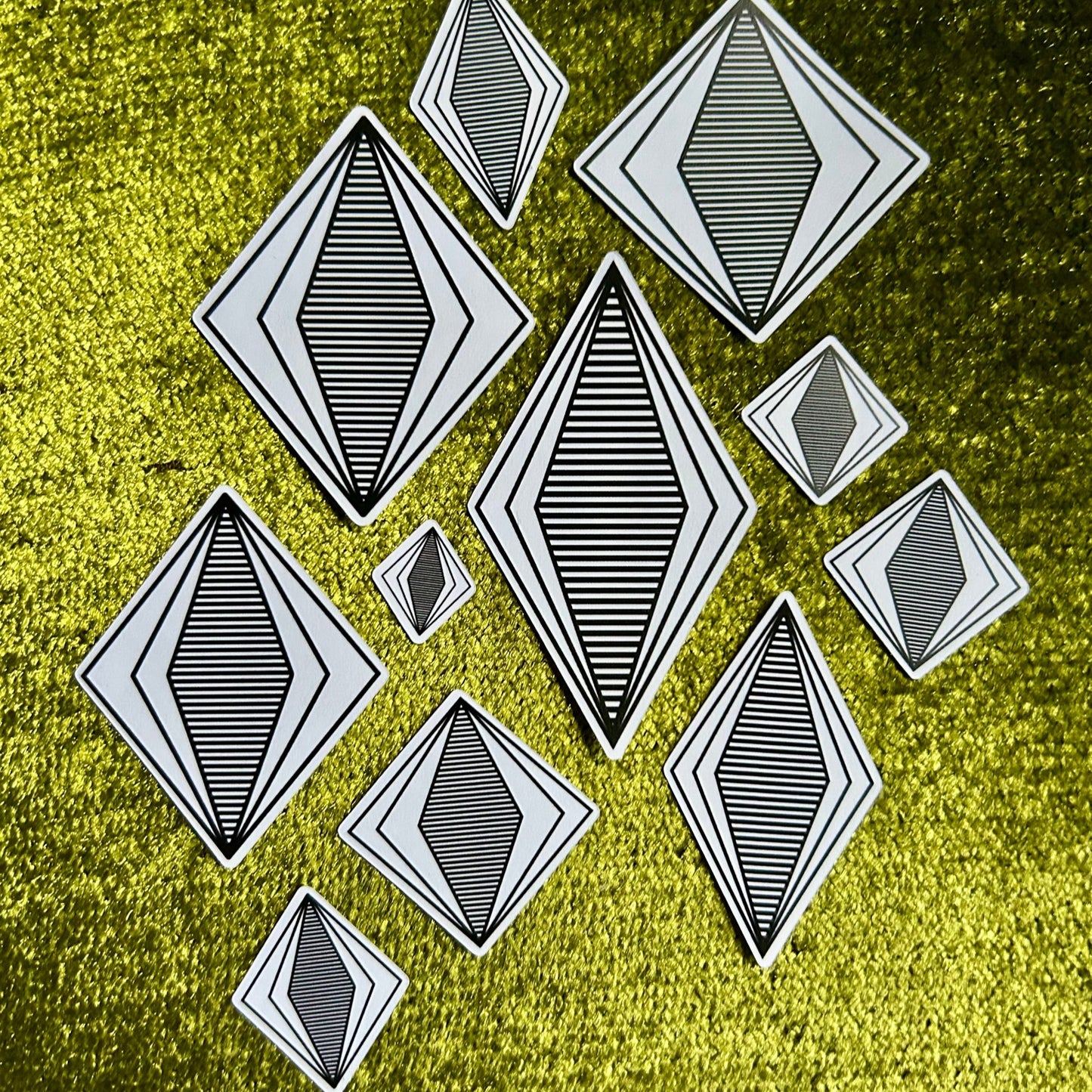 Black geometric shapes on a textured green background