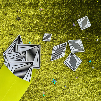 Geometric shapes on a grassy field with a yellow tent.