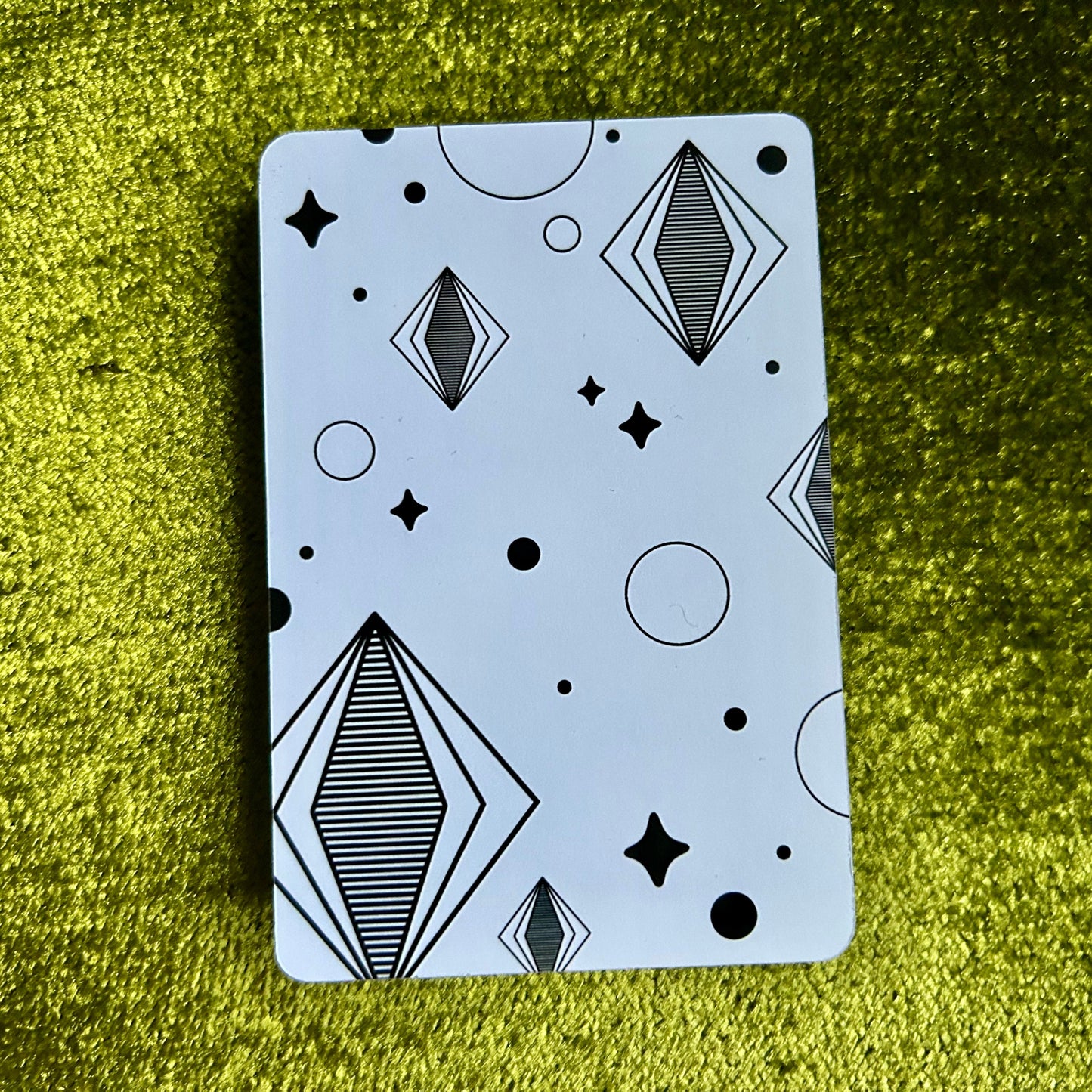 art print with geometric pattern on a green textured surface