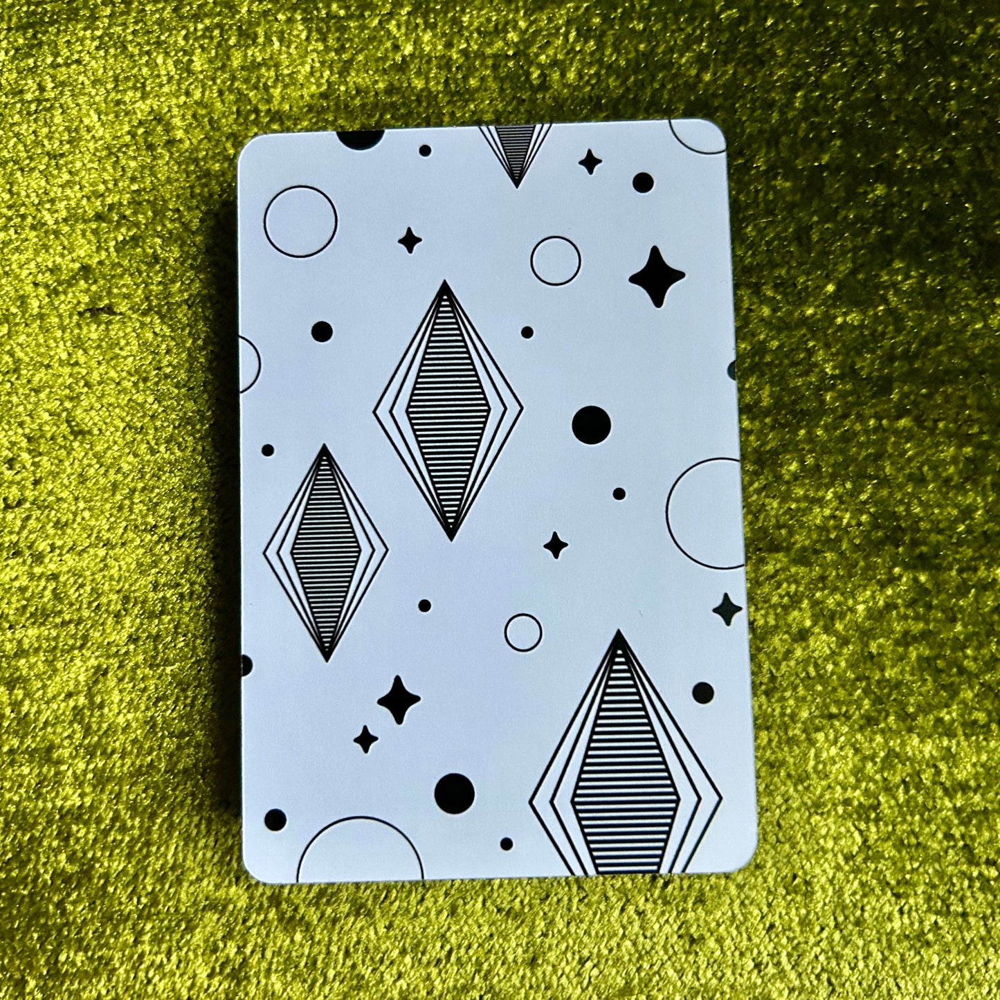 art print with geometric pattern on a green textured surface