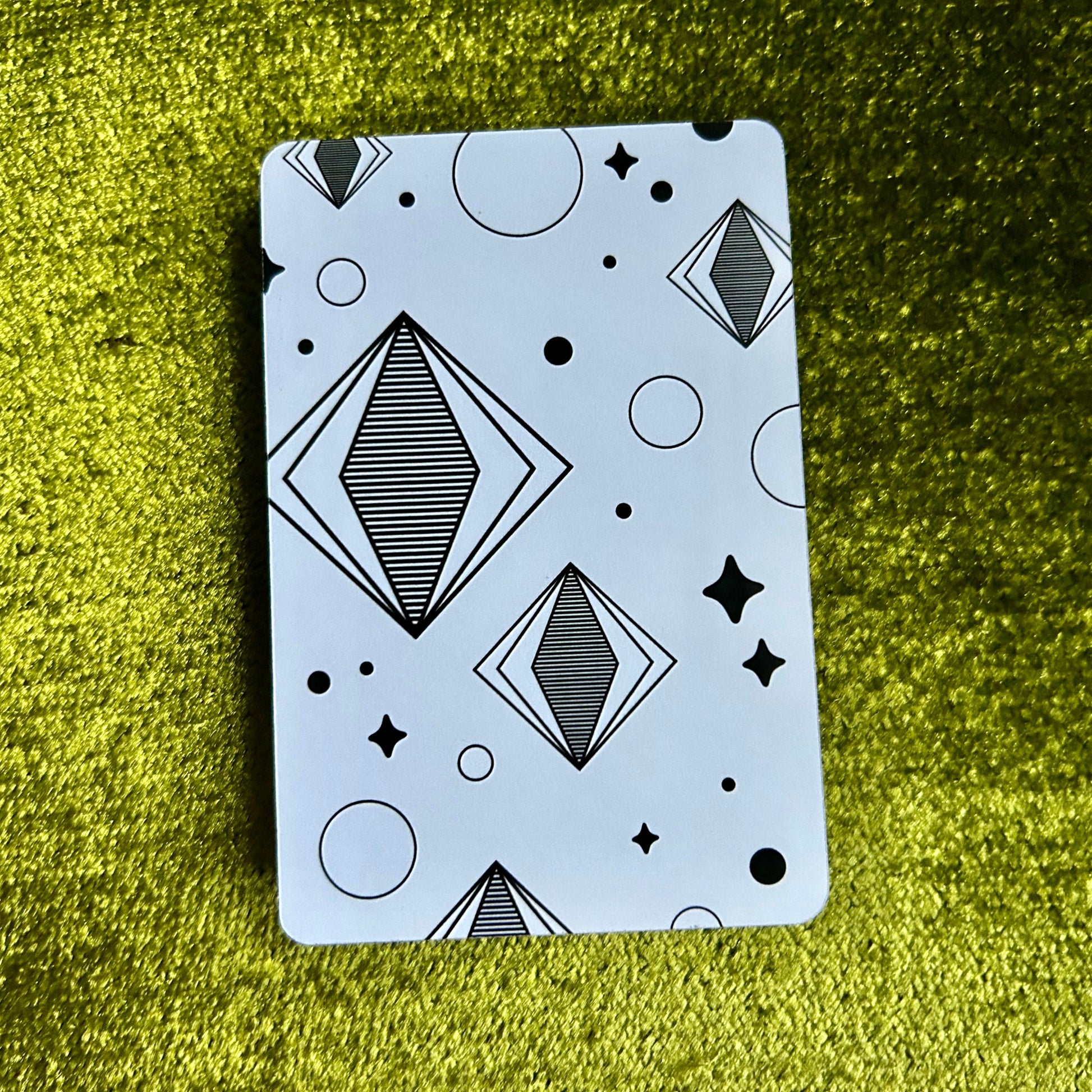 sticker sheet with geometric pattern on a green textured surface