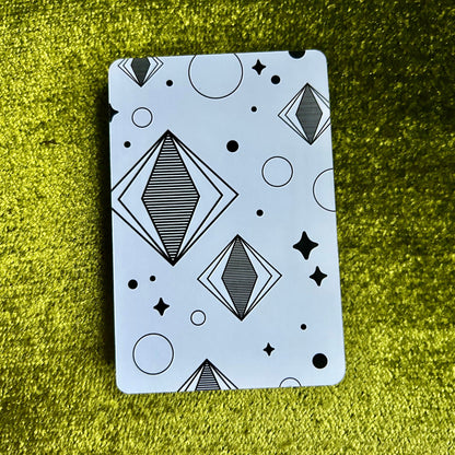 sticker sheet with geometric pattern on a green textured surface