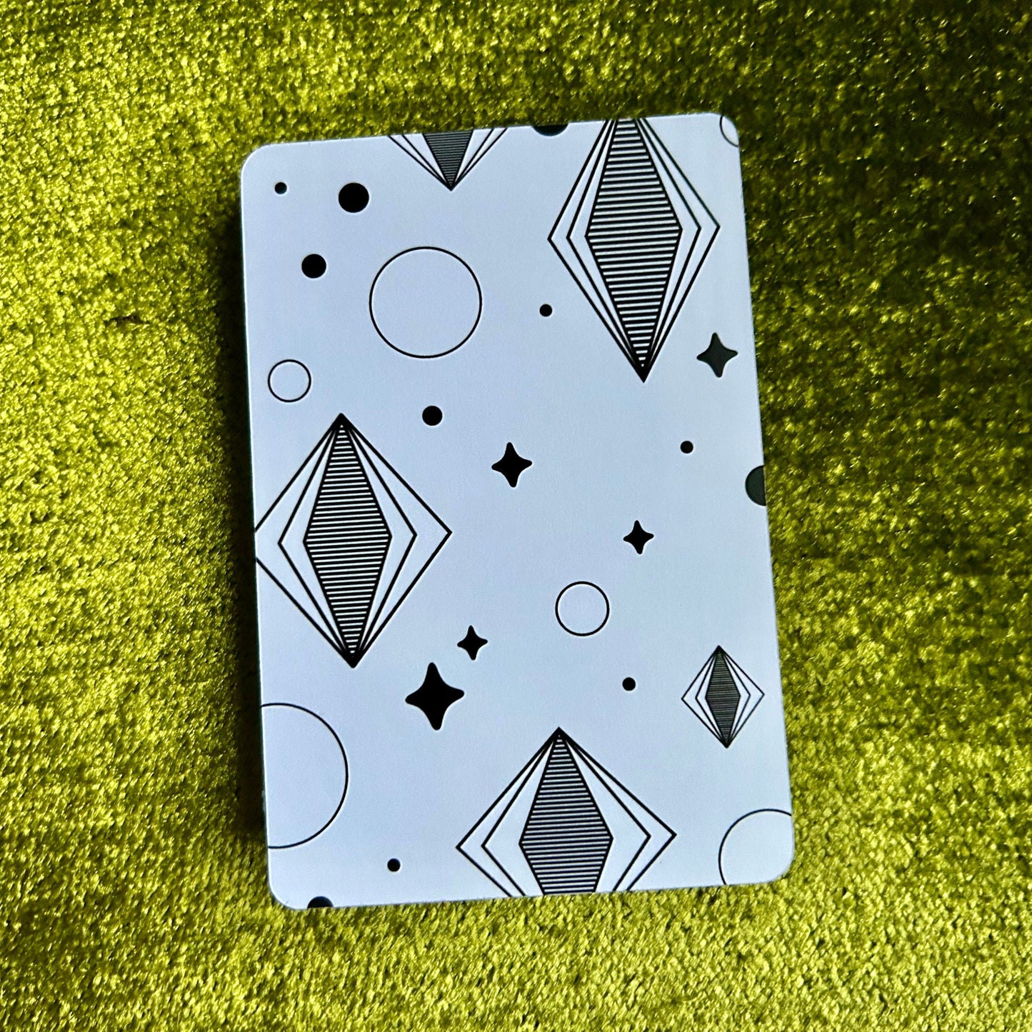 sticker sheet with geometric pattern on a green textured surface