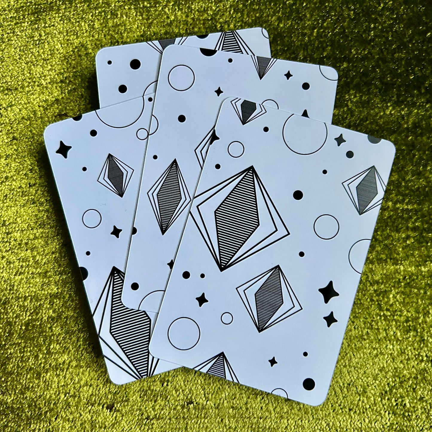 art prints with geometric patterns on a green textured surface