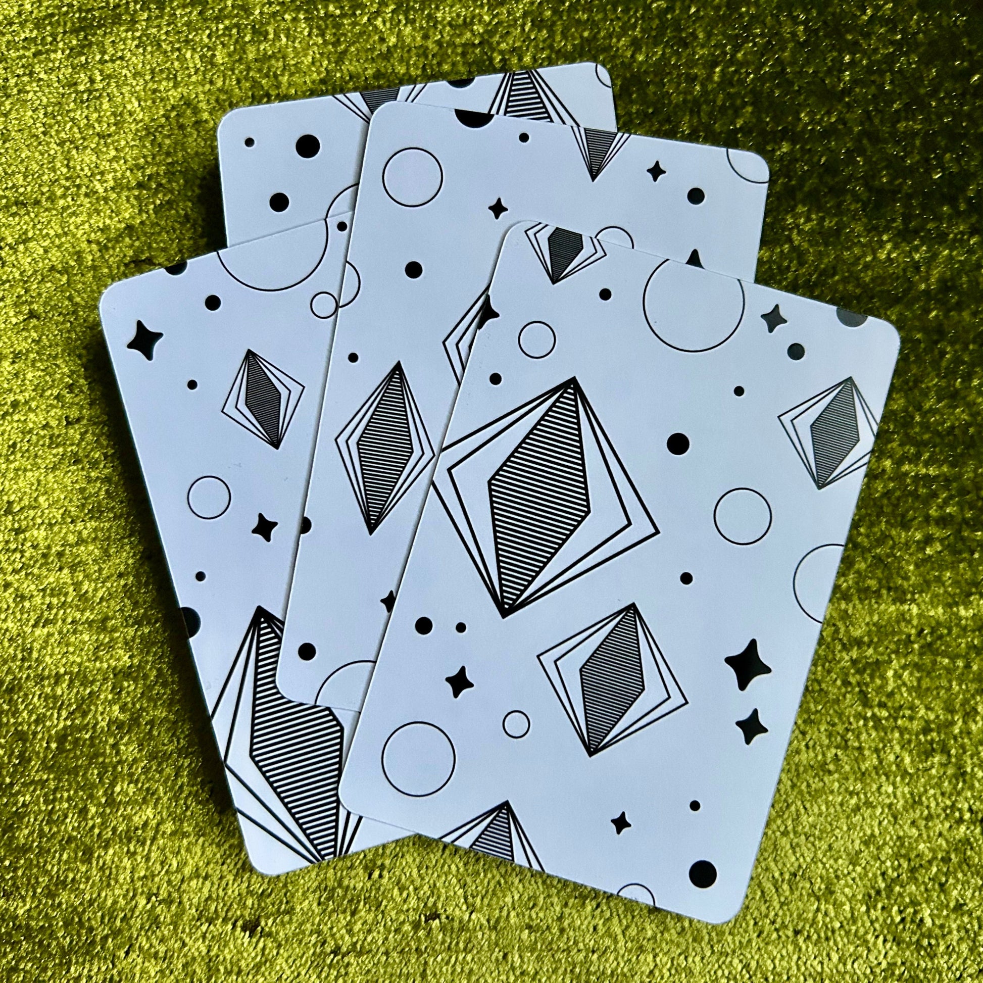 art prints with geometric patterns on a green textured surface