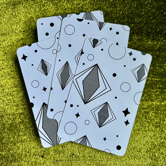 art prints with geometric patterns on a green textured surface