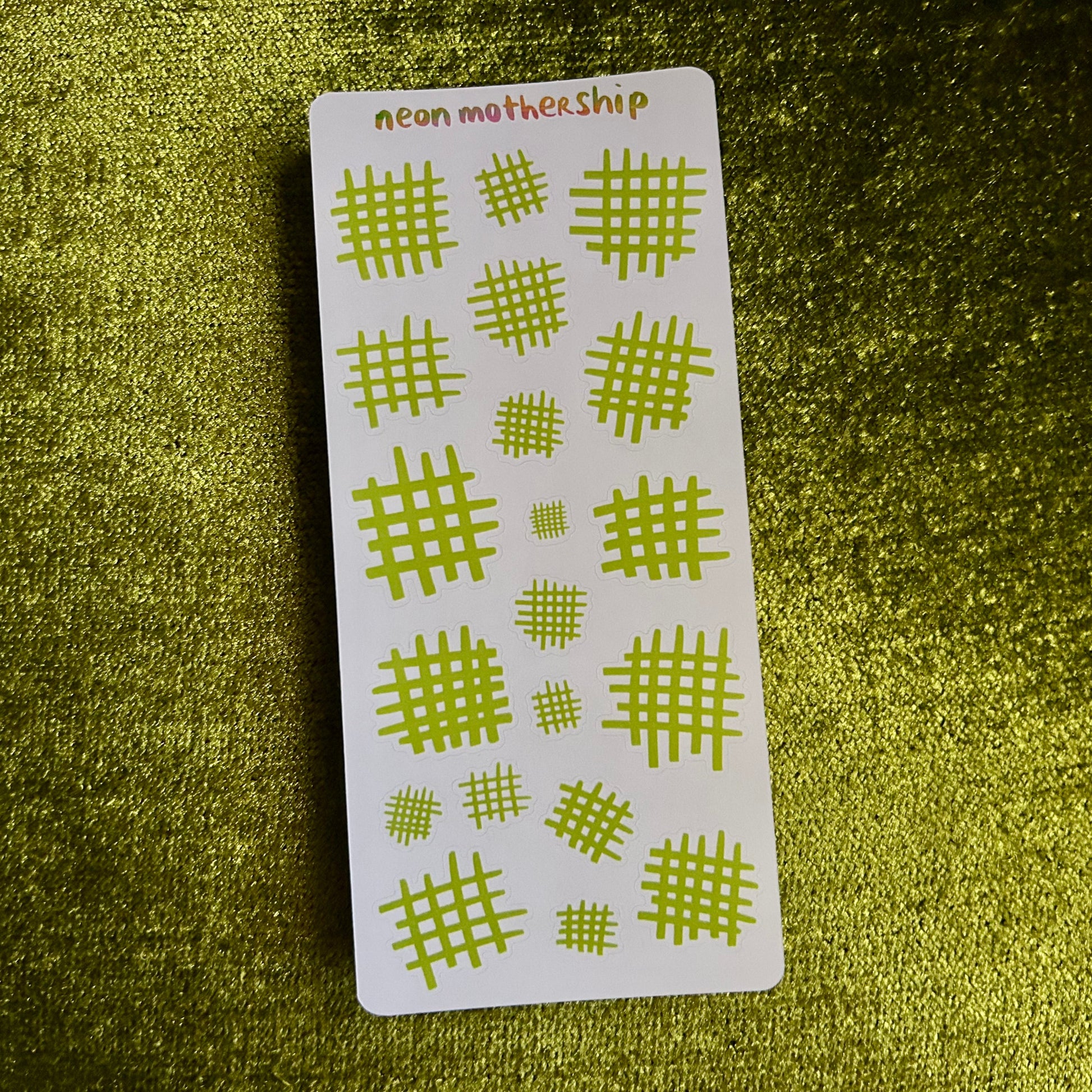 sticker sheet with green grid patterns on a green textured background