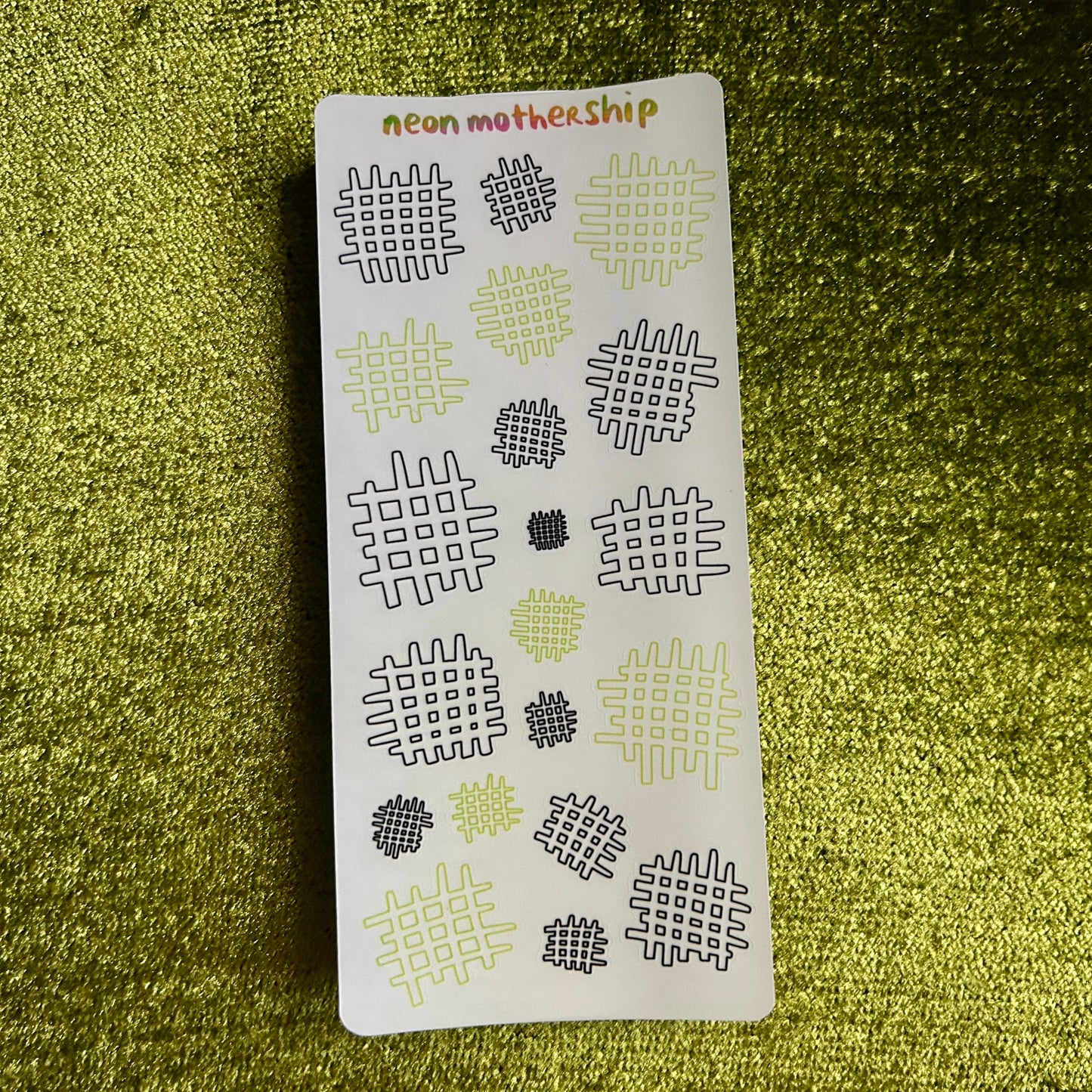 Card with geometric patterns on a green textured surface