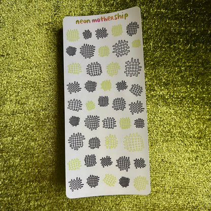 Sticker sheet with geometric waffle pattern on a green textured background