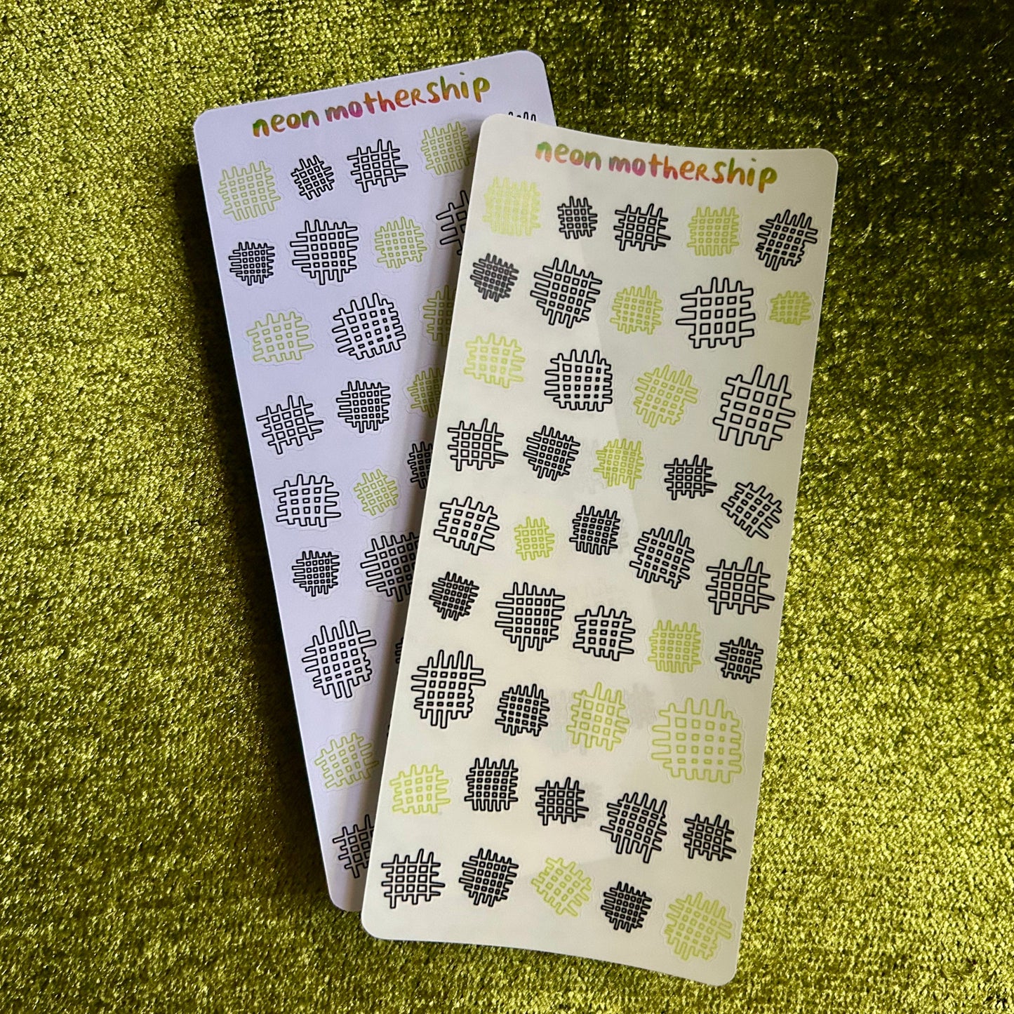 two sticker sheets with black and green geometric designs