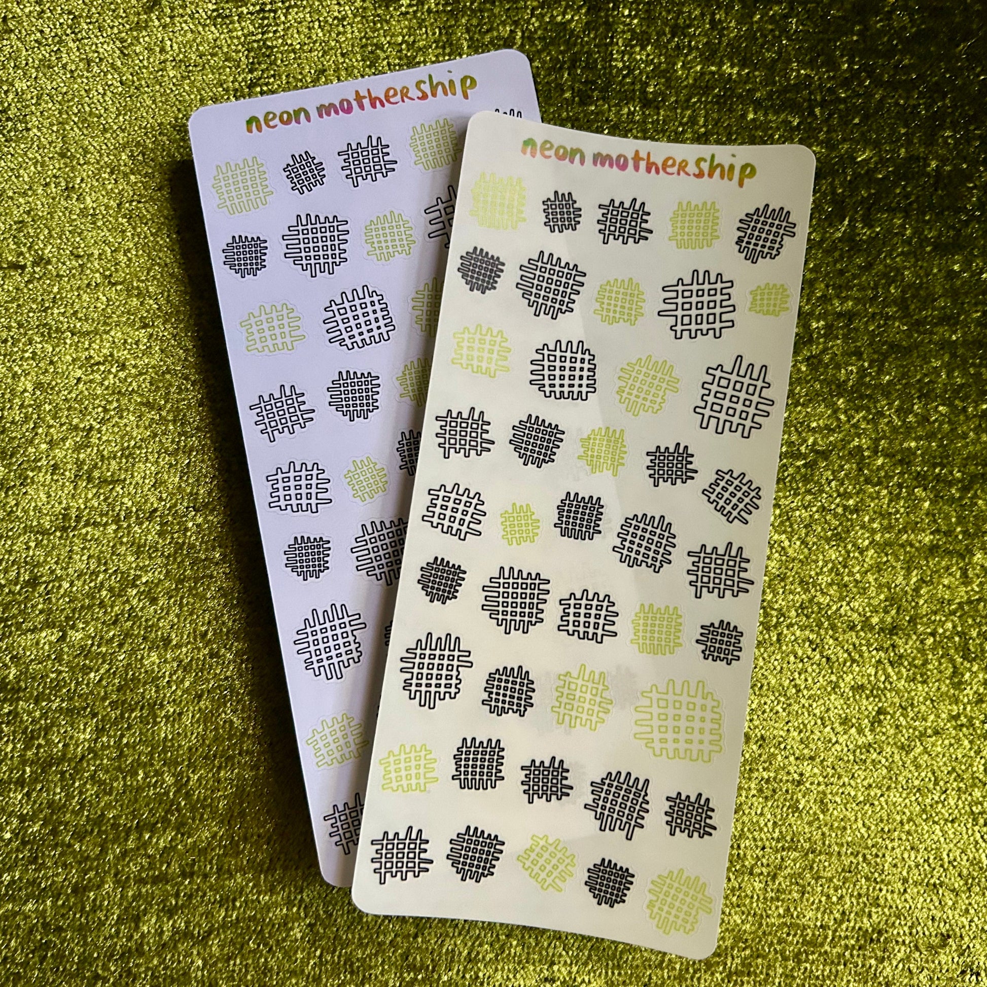 two sticker sheets with black and green geometric designs