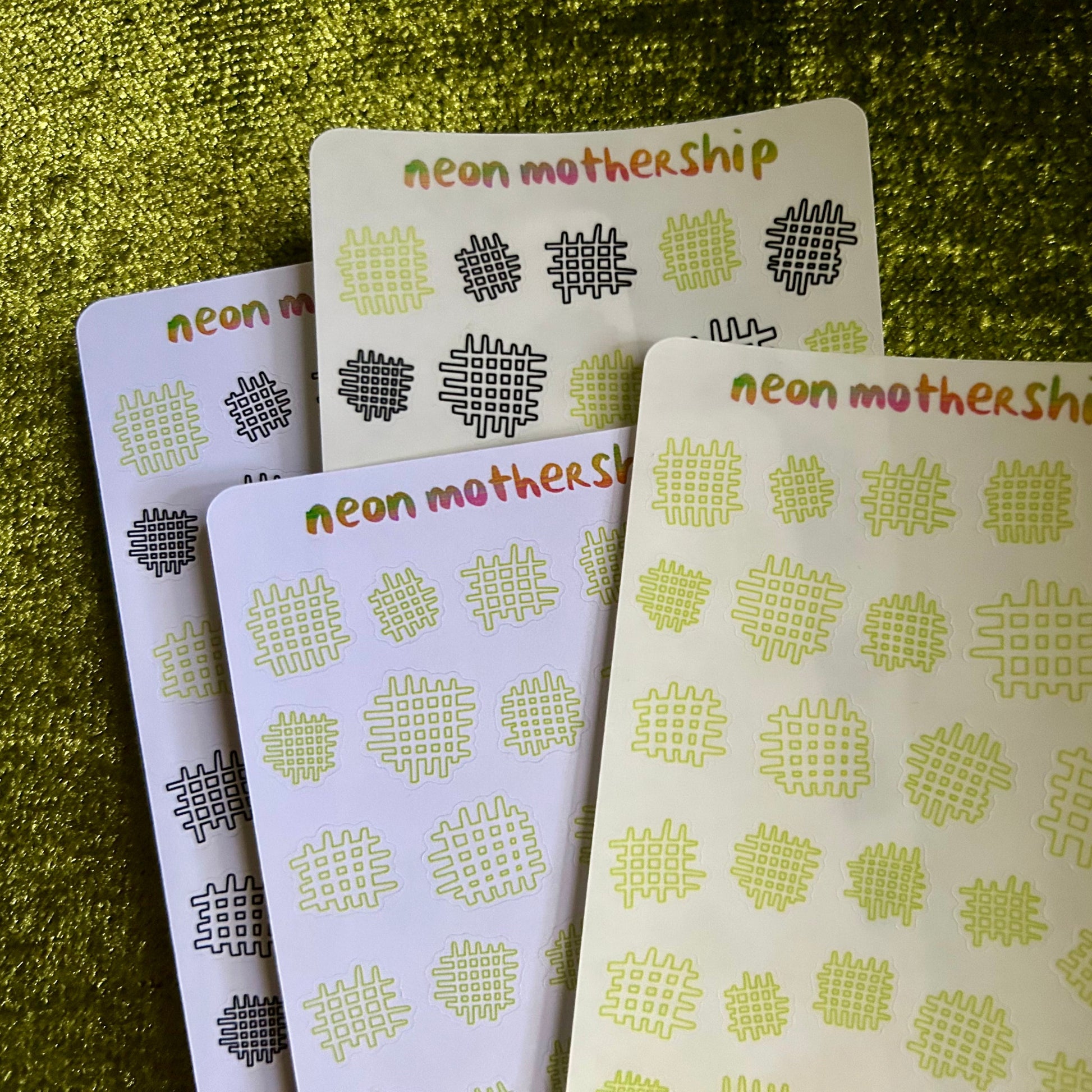 Four cards with 'neon mothership' branding on a green textured background