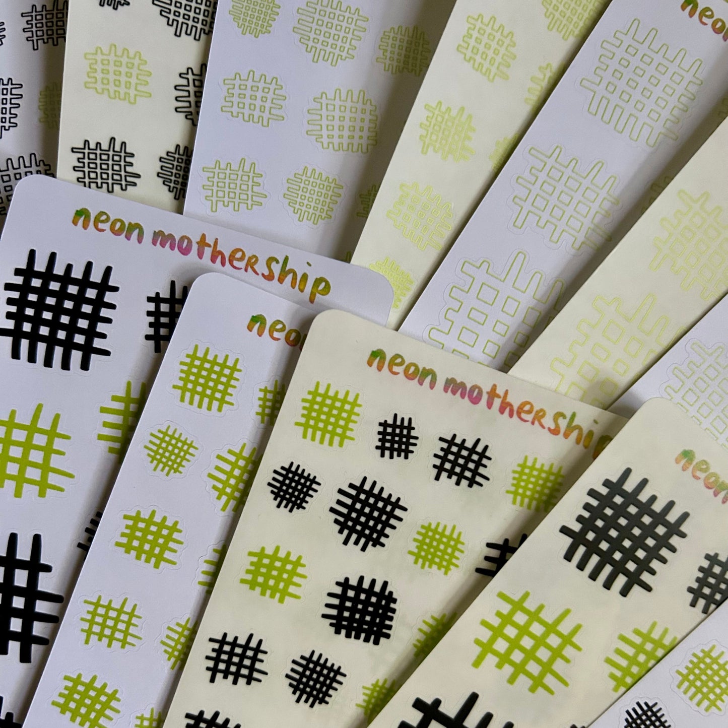 Stack of cards with geometric patterns and 'neon mothership' branding.