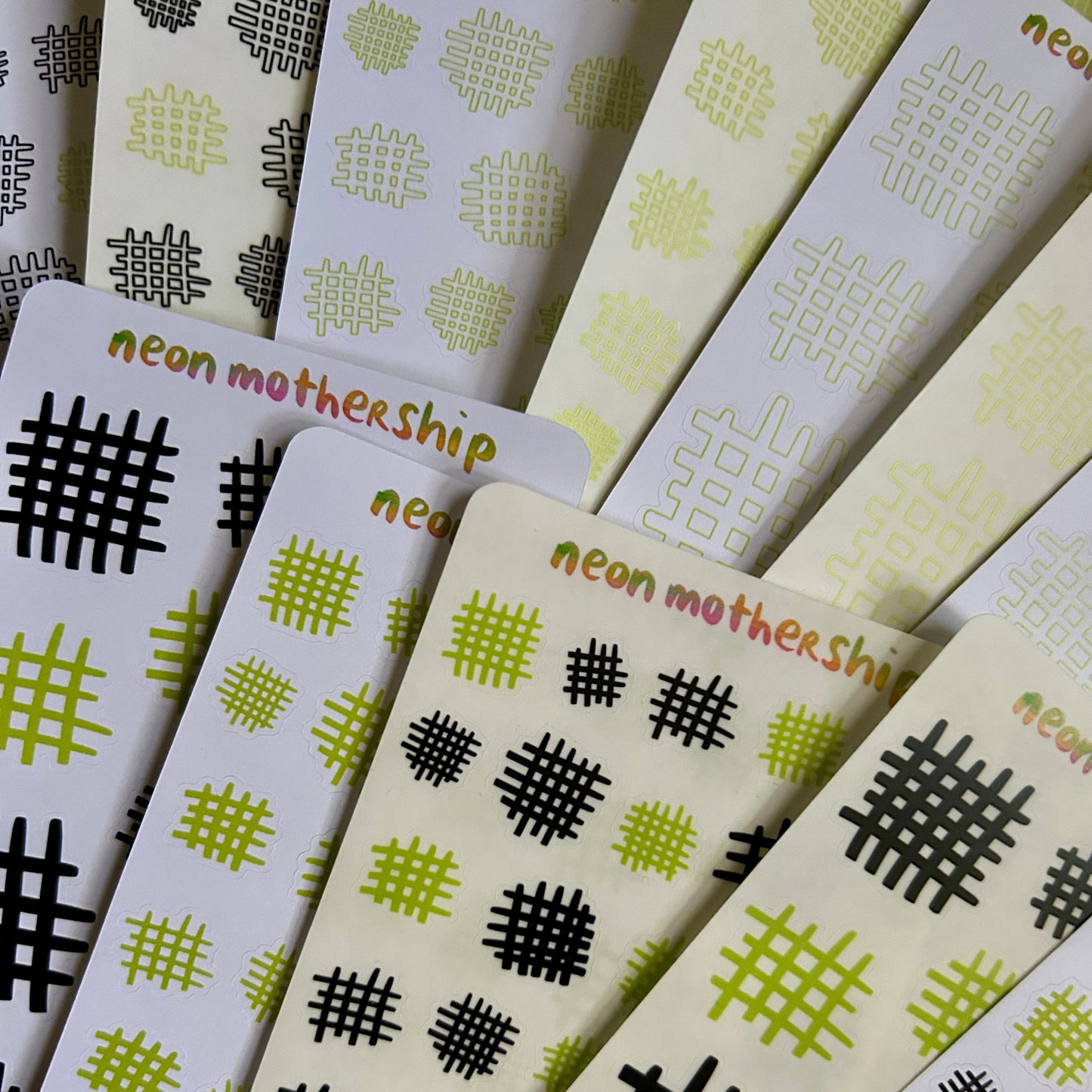 Stack of cards with geometric patterns and 'neon mothership' branding.