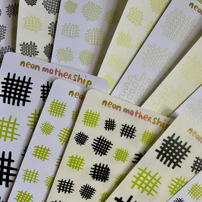 Stack of cards with geometric patterns and 'neon mothership' branding.
