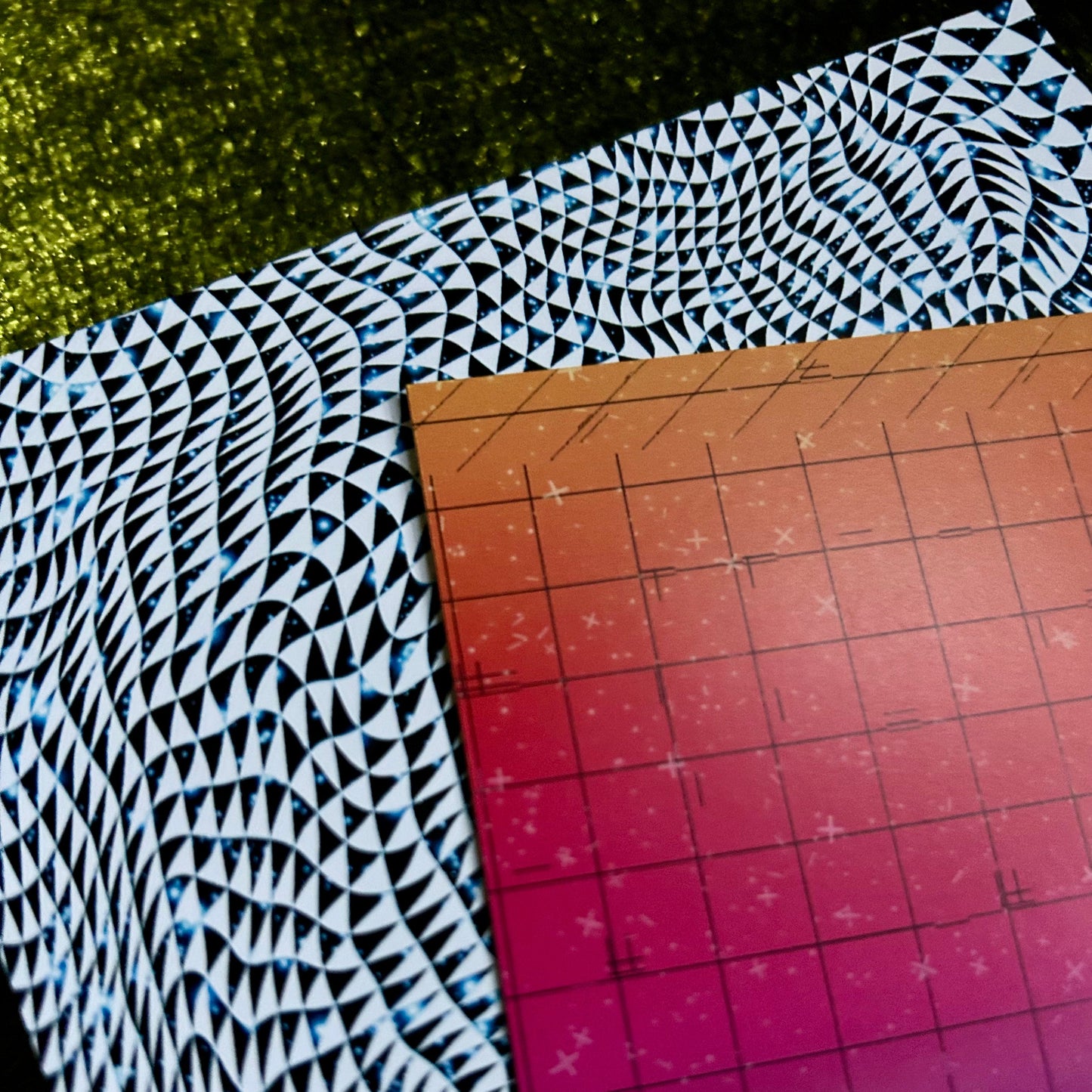 postcard with a black and white pattern on a cutting mat with grid lines.