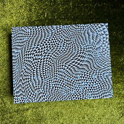 Black, blue and white cosmic patterned postcard on a green grass background