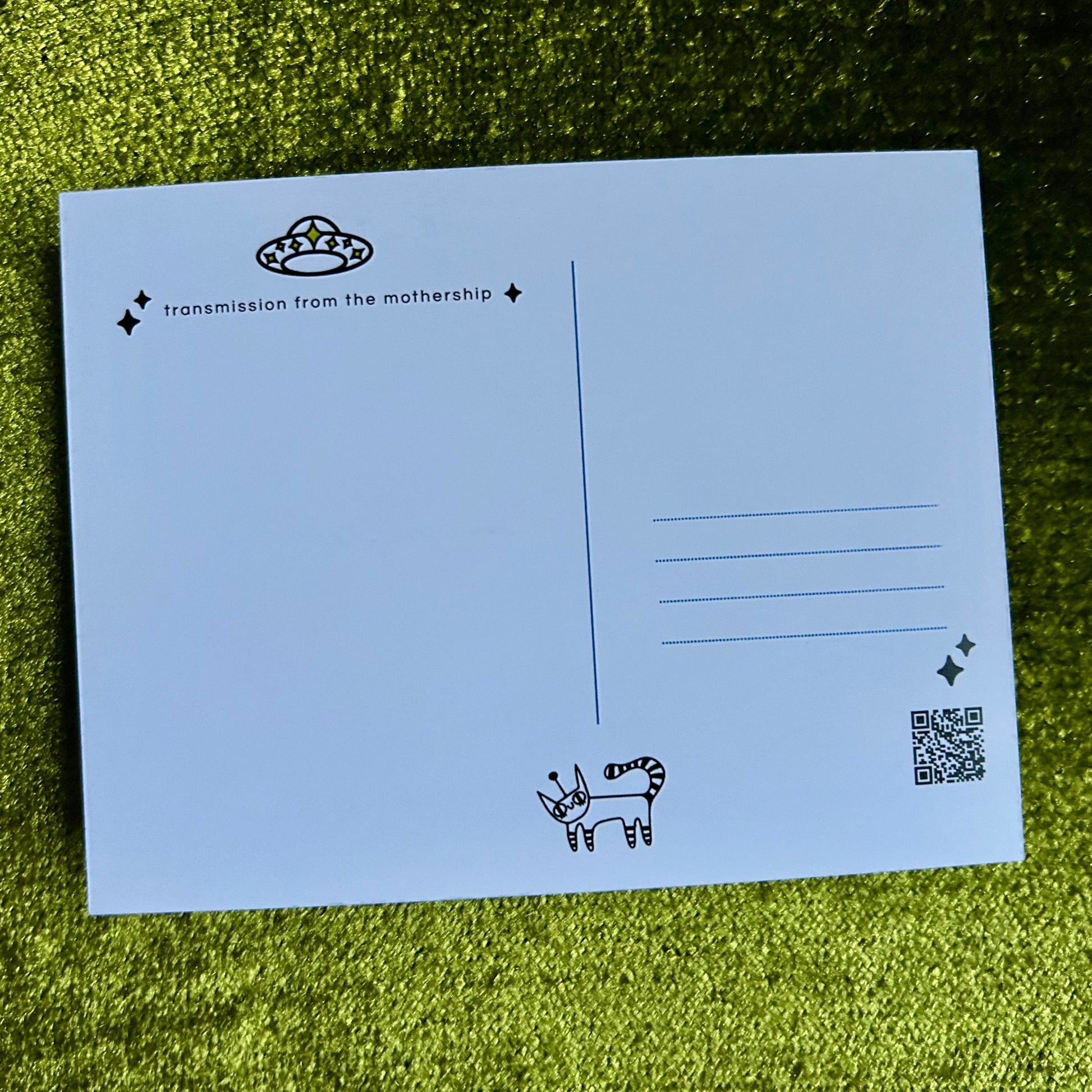 postcard with black text and illustrations on a green grass background