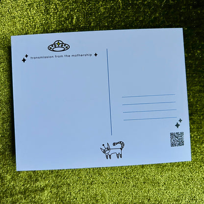 postcard with black text and illustrations on a green grass background