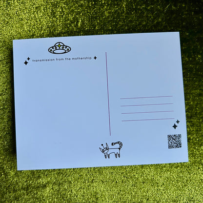 Blue postcard with black text and graphics on a green grass background