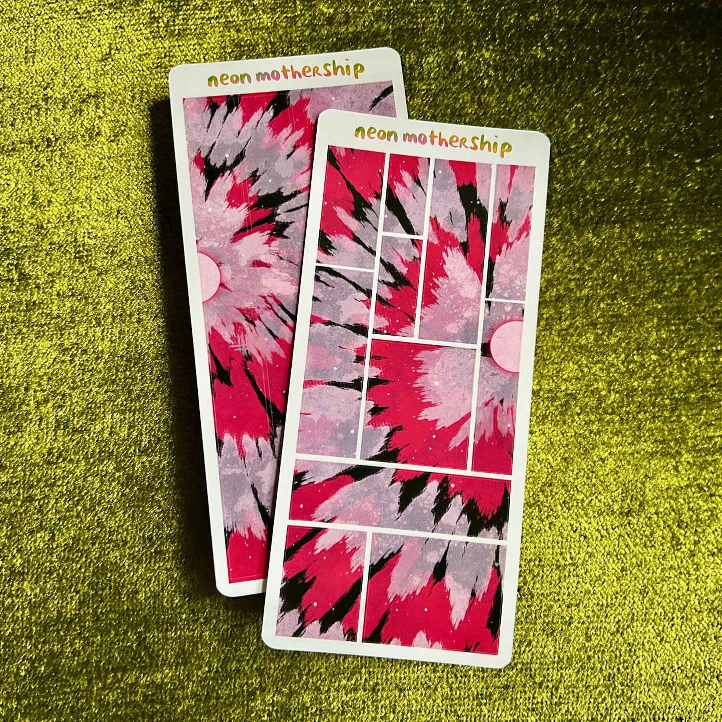 Two sticker sheets with a red and black abstract design on a green textured surface