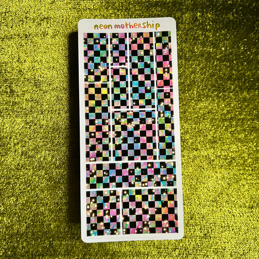 Checkered sticker sheet with 'neon mother ship' text on a green textured background