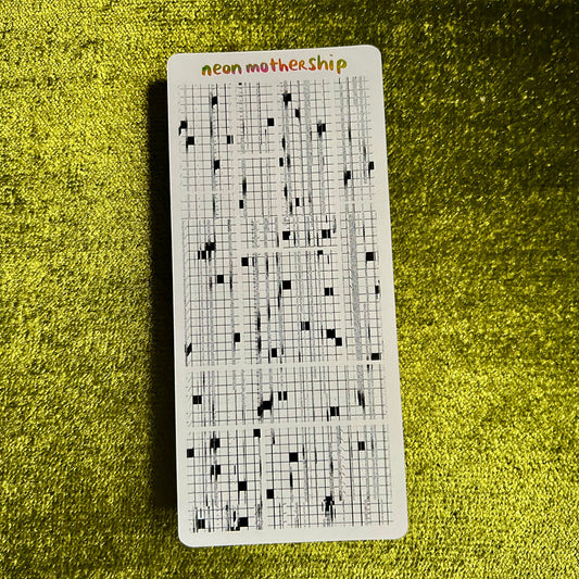 Sticker sheet with grid pattern and 'neon motherShip' text on a green textured surface