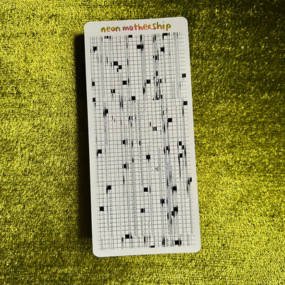 Grid sticker sheet with 'neon mothership' text on a textured green surface