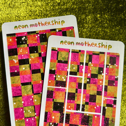 Two colorful checkered sticker sheets with 'neon mothership' branding on a green textured background.