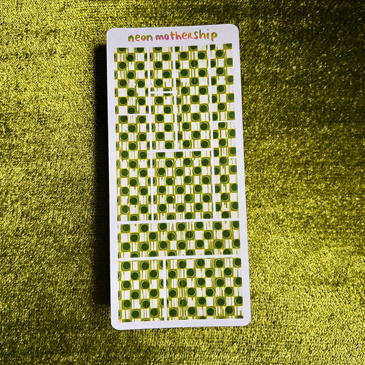 sticker sheet with green and white pattern on a textured green surface