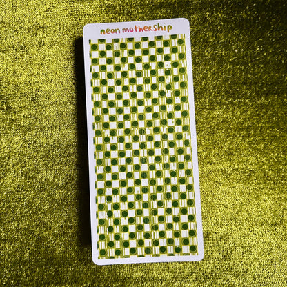 Checkered sticker sheet with 'neon mothership' text on a green textured background