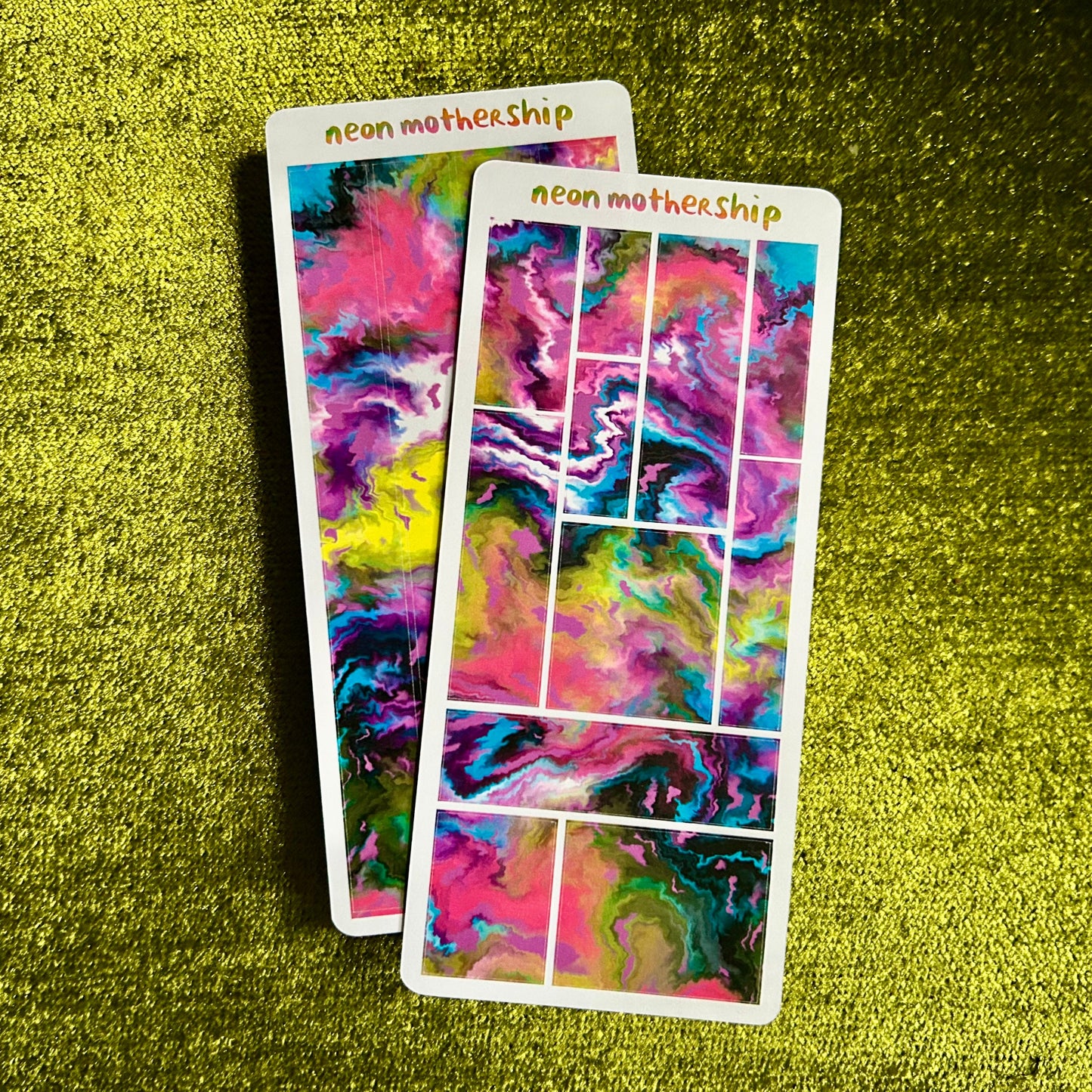 Two colorful abstract sticker sheets with 'neon mothership' branding on a green textured background.