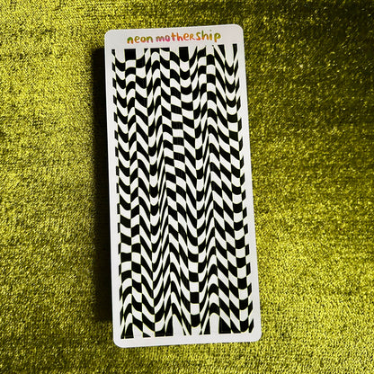 Black and white patterned sticker sheet with 'neon mothership' branding on a green textured background
