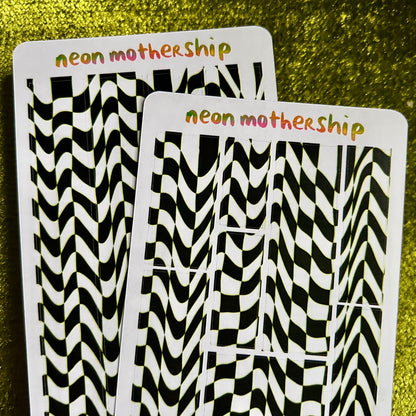 Two sticker sheets with black and white zigzag patterns on a green textured background, labeled 'neon mothership'.
