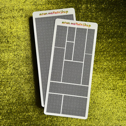 Two sticker sheets with geometric designs and 'neon motherhip' text on a green textured surface.