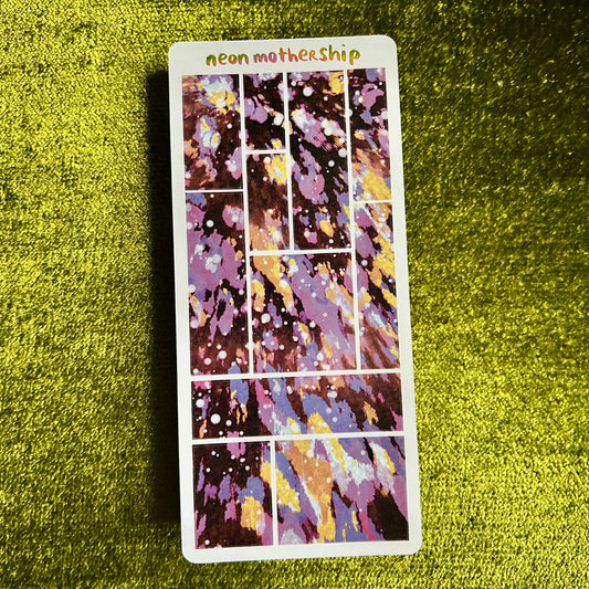 Colorful sticker sheet with 'neon mother ship' text on a green textured surface
