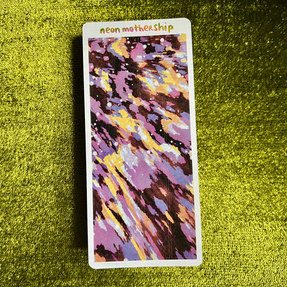 Colorful sticker sheet with 'neon mothership' text on a green textured surface