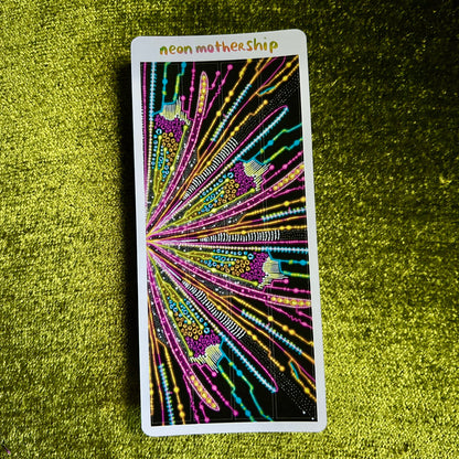 Colorful sticker sheet with 'neon motherShip' text on a green textured surface