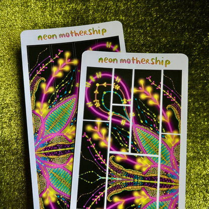 Two neon 'neon mothership' sticker sheets on a green textured surface