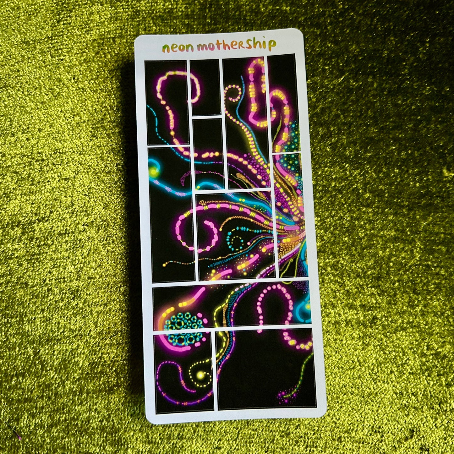 Neon-themed sticker sheet with abstract designs on a green textured surface