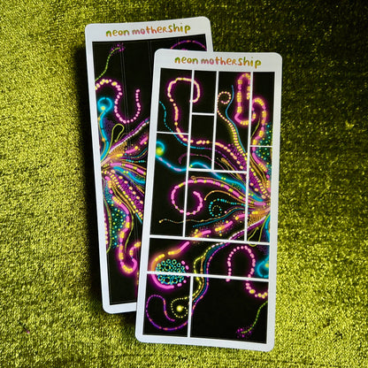 Two colorful sticker sheets with neon patterns on a green textured surface