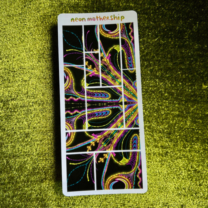 sticker sheet with colorful design on a green textured surface