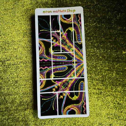 sticker sheet with colorful design on a green textured surface