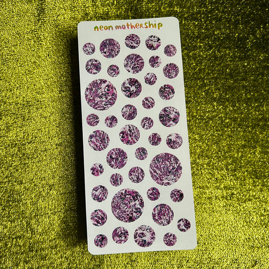 Card with purple circular patterns on a green textured background