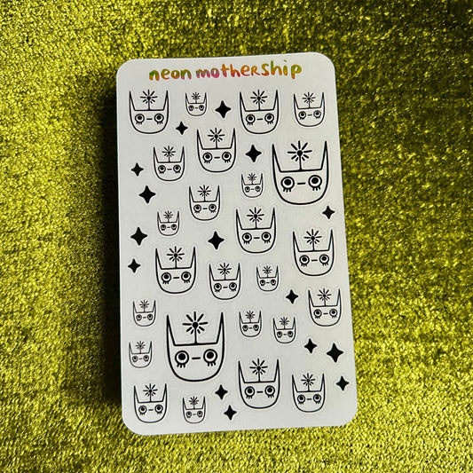Sheet of black and white cat-themed stickers on a green textured background with 'neon mother ship' text.